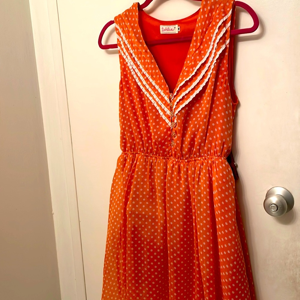 Unique vintage dress with gold rosebud buttons. Embellished with a brown belt.